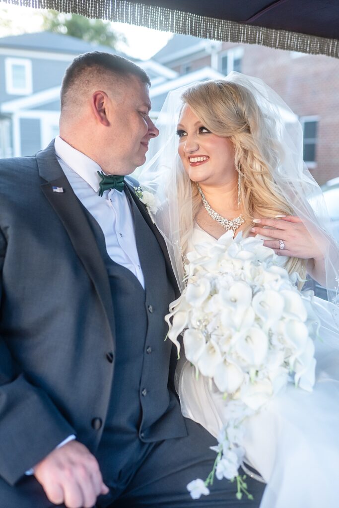 Newlyweds riding in a horse-drawn carriage through downtown Fredericksburg Virginia