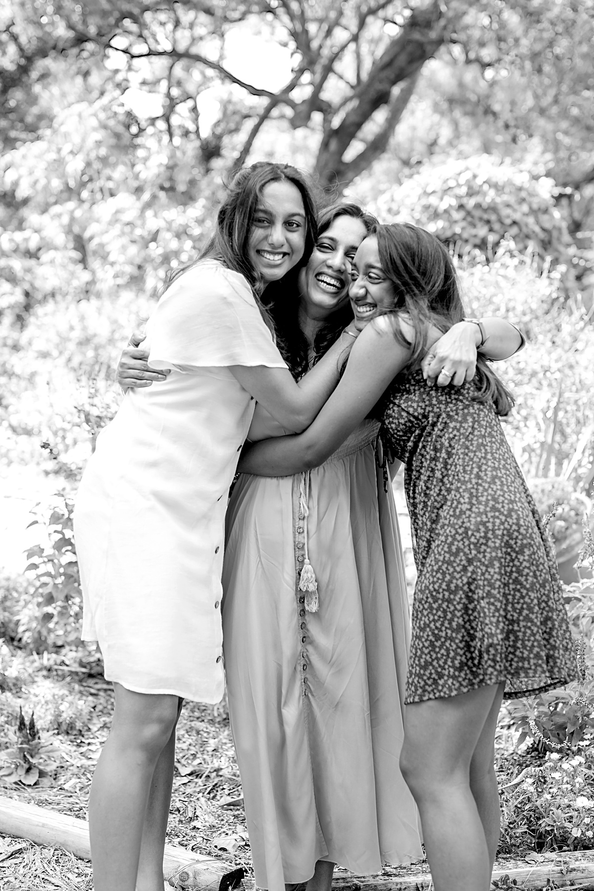 Mother and daughters hug for family professional photograph