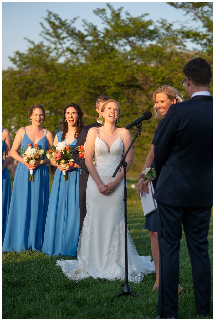 Bride laughs during her wedding ceremony at the Arboretum.