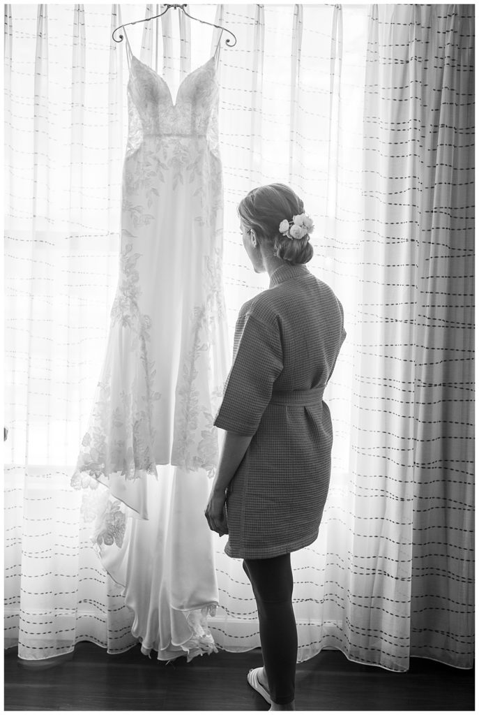 Bride looks at dress before her wedding at the National Arboretum.