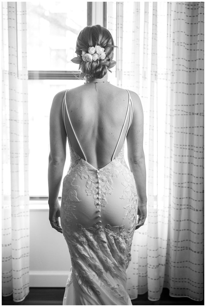 Bride shows back of dress and hairstyle for DC wedding.
