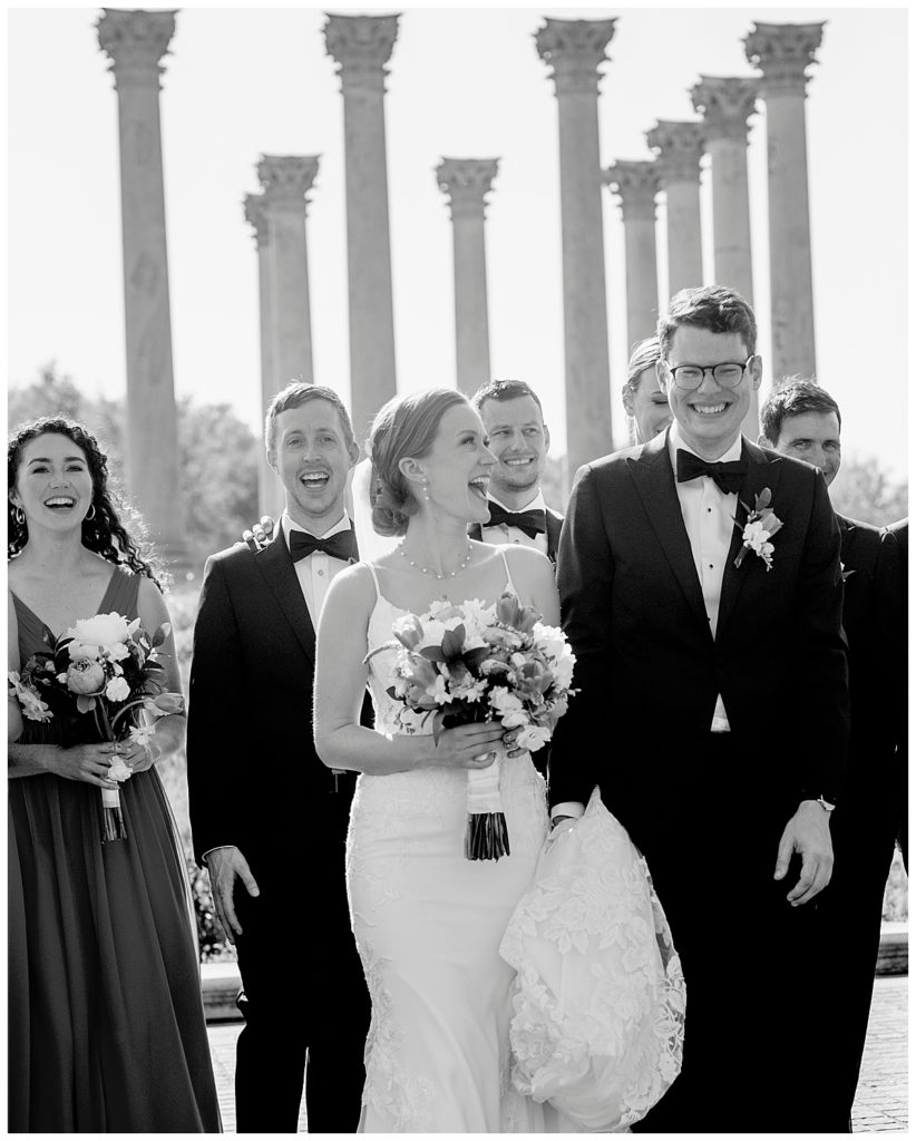 Wedding party walks by columns in the U.S. National Arboretum
