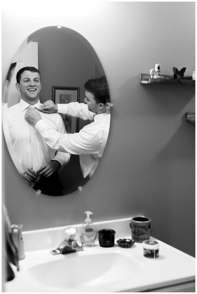Groom gets ready for wedding at home in Maryland.
