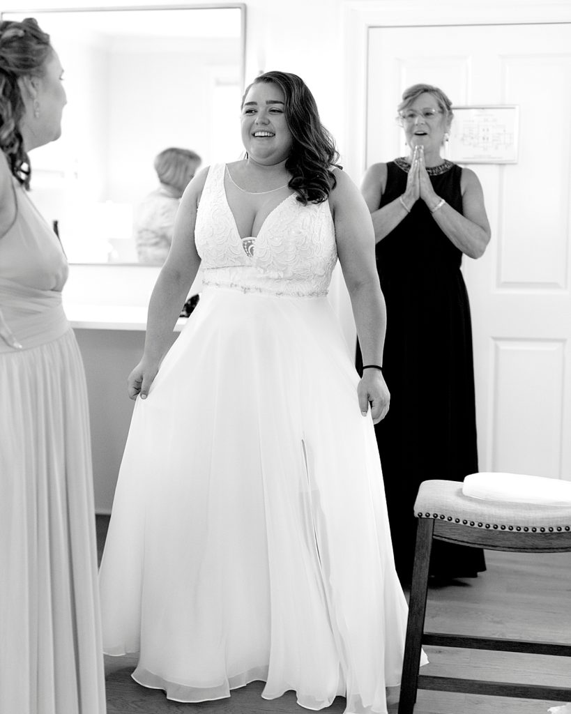 Mom is thrilled as she looks at daughter in her dress by Nadine Nasby Photography, Eastern Shore Maryland wedding photographer.