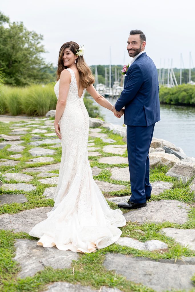 Bride and groom walk along Chesapeake Bay for wedding portraits