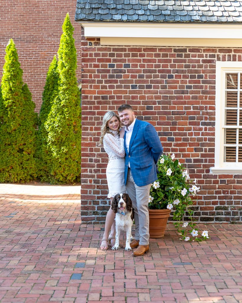 Engaged couple poses with dog at the Paca House in Annapolis by Annapolis Wedding Photographer Nadine Nasby Photography.