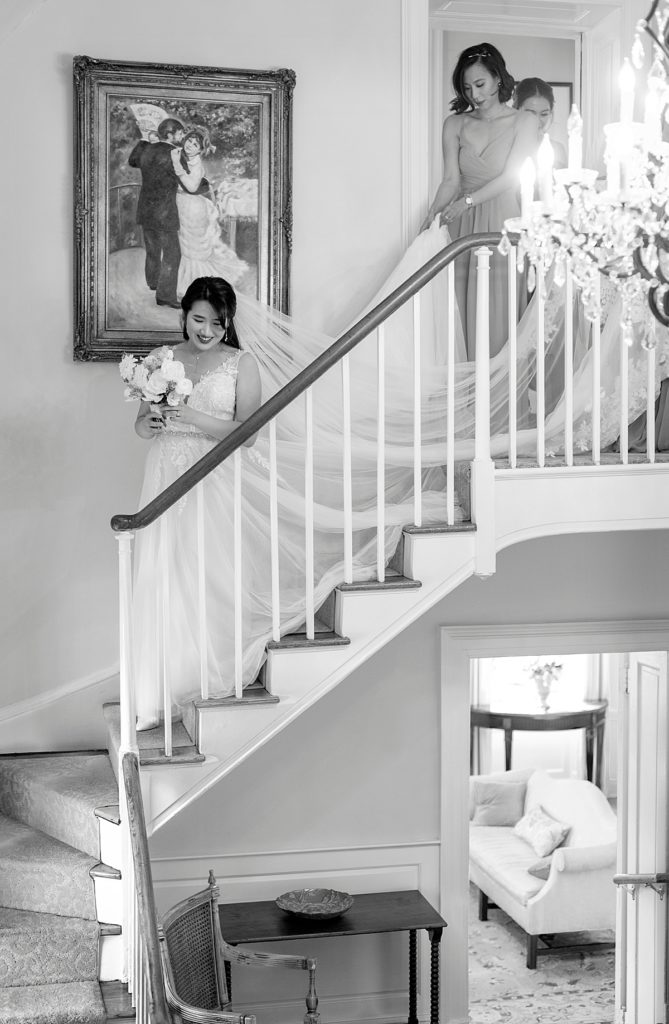 Bride walks downstairs at the Belmont Manor