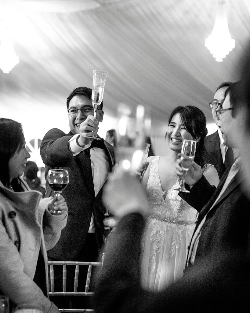 Couple and guest toast at Maryland wedding venue Belmont Manor.