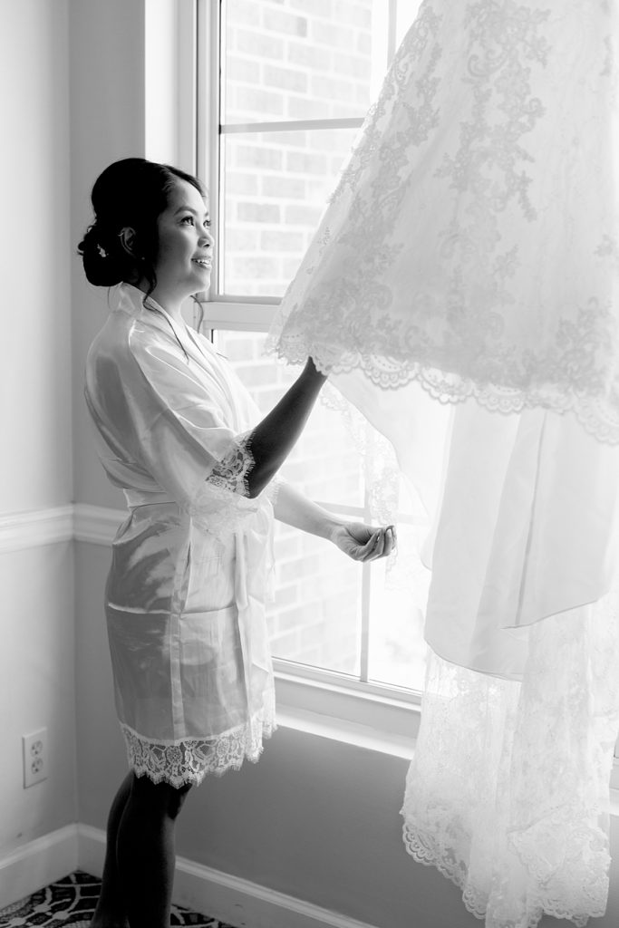 Bride looks at dress before her DC wedding.