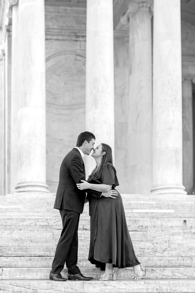 Engaged couple kiss at the Jefferson Memorial 