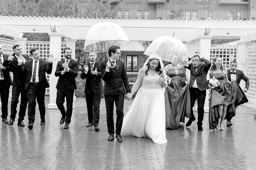 Wedding party walks in the rain - Chesapeake Bay Beach Club, a Washington DC Waterfront wedding venue