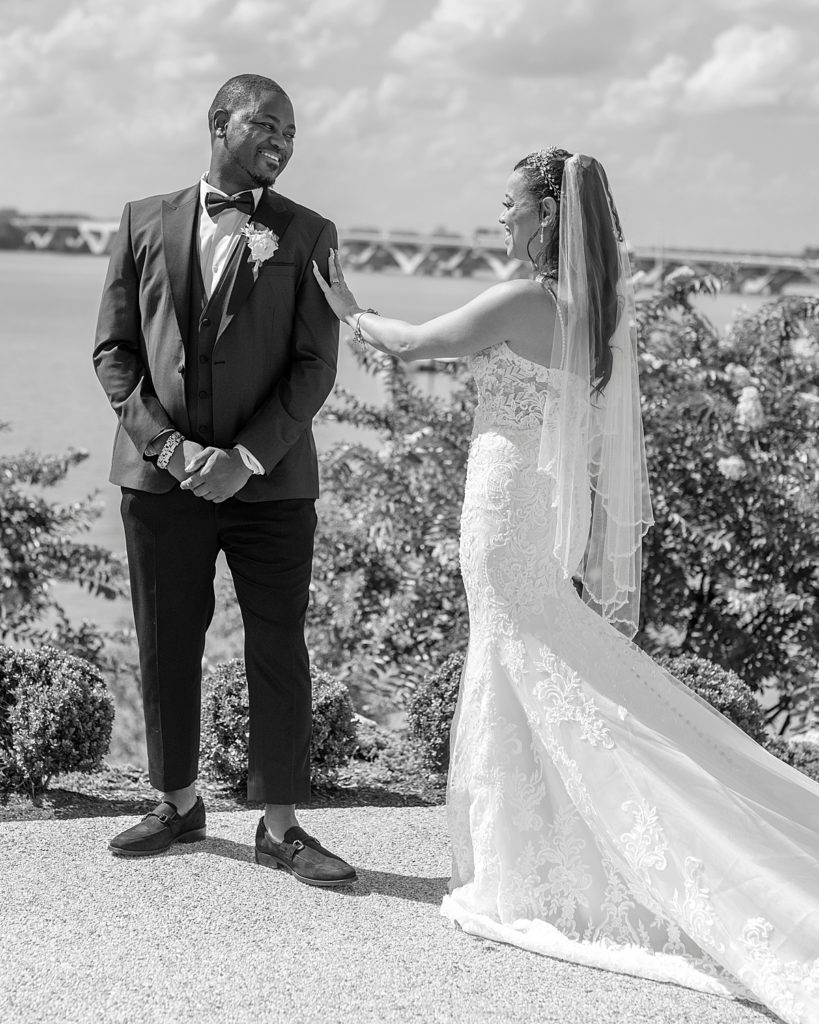 Grooms smiles his bride for first look at their Washington National Harbor wedding