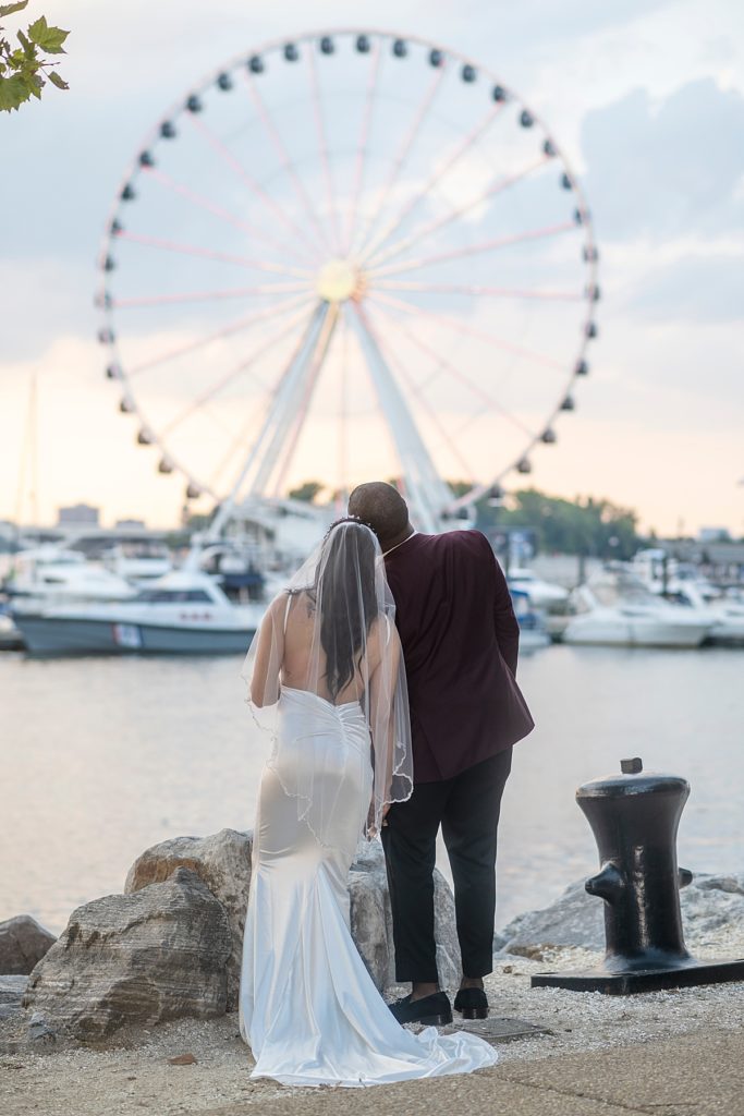 Wedding couple watch the lights of the Capitol Wheel at the National Harbor