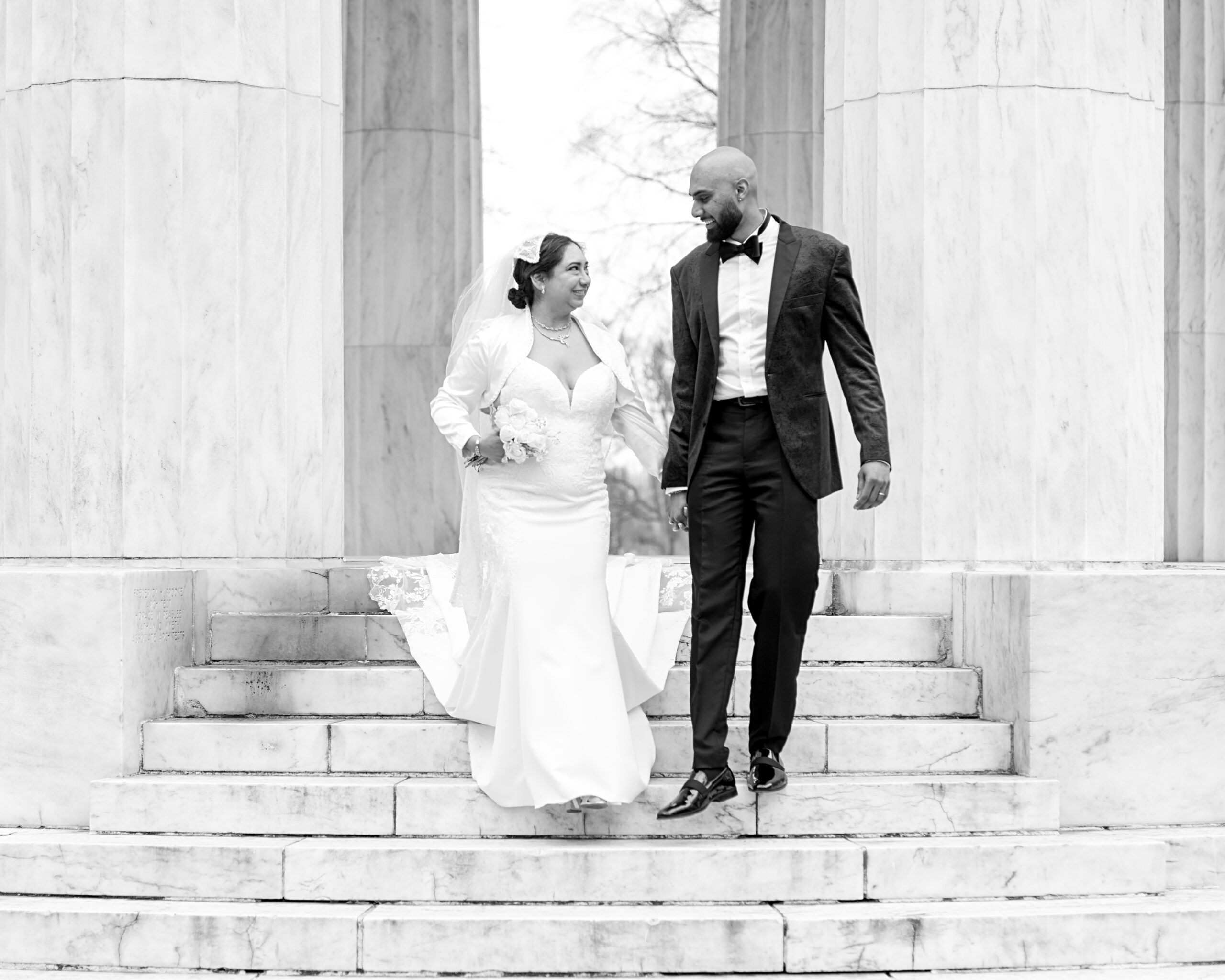 Wedding couple walk down steps after ceremony at the DC War Memorial