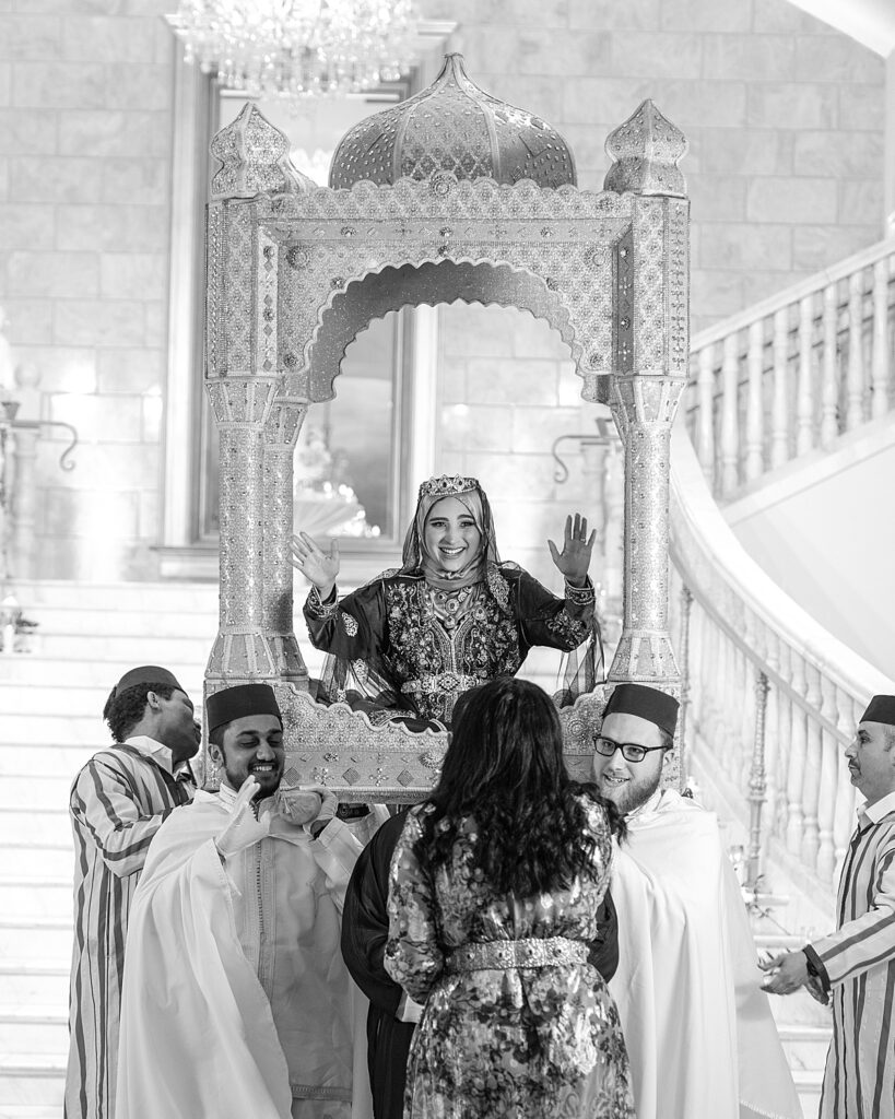 Bride is carried in an amaria during Moroccan wedding reception at The Bellevue Event Center