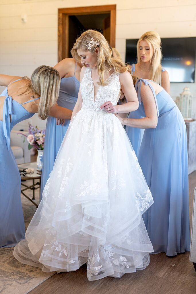 Bridesmaids help bride get ready for wedding at Kent Island Resort