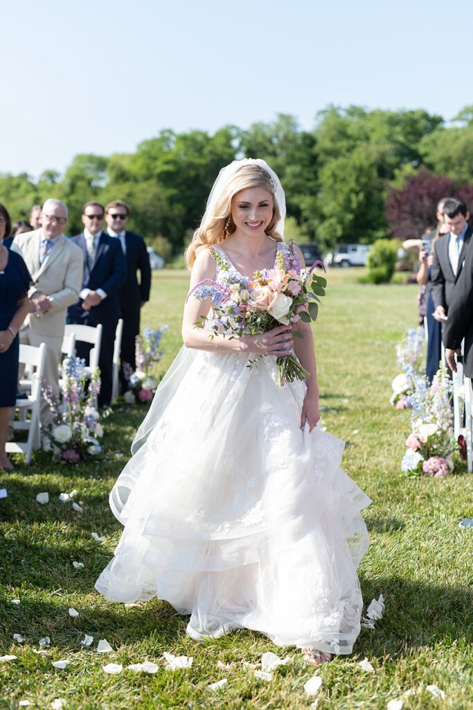 Bride walks down aisle at Kent Island Resort