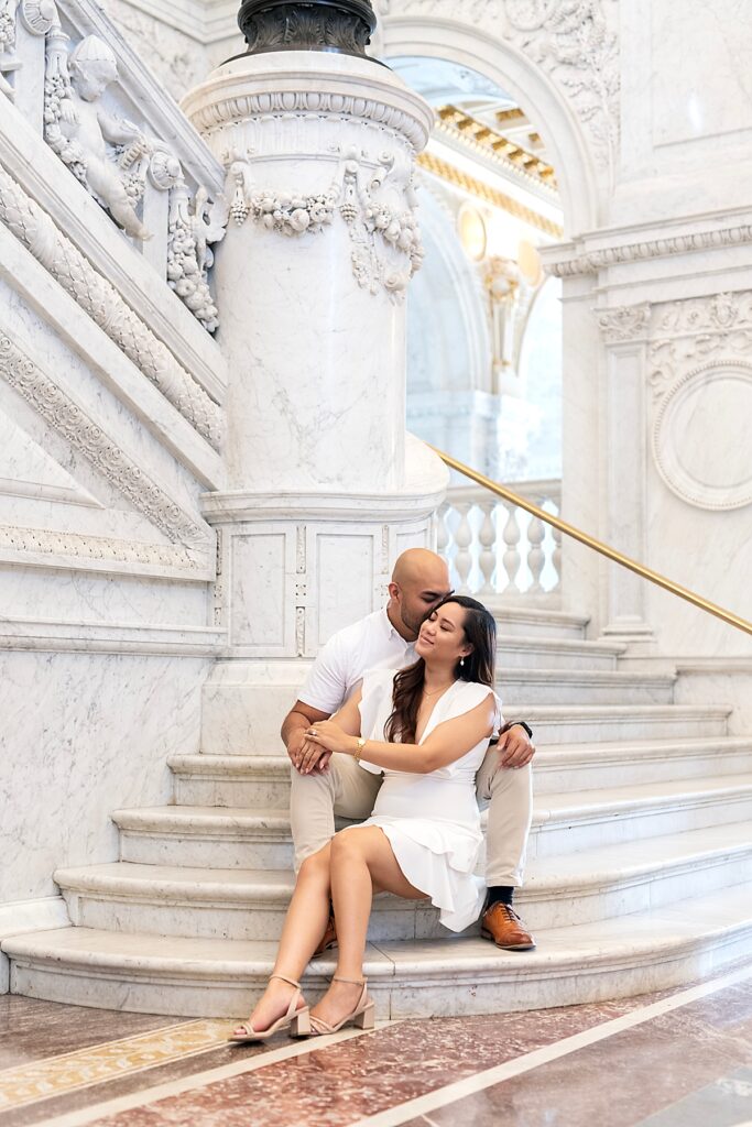 Couple embrace on the indoor steps of the Library of Congress for their engagement photos in DC