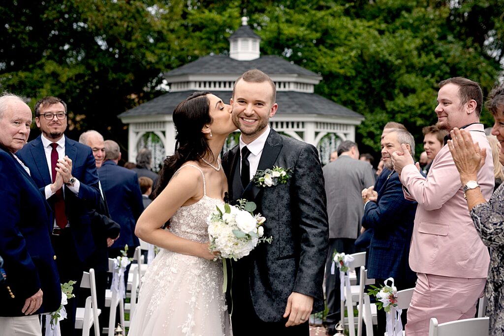 Celebration kiss at Grey Rock Mansion wedding