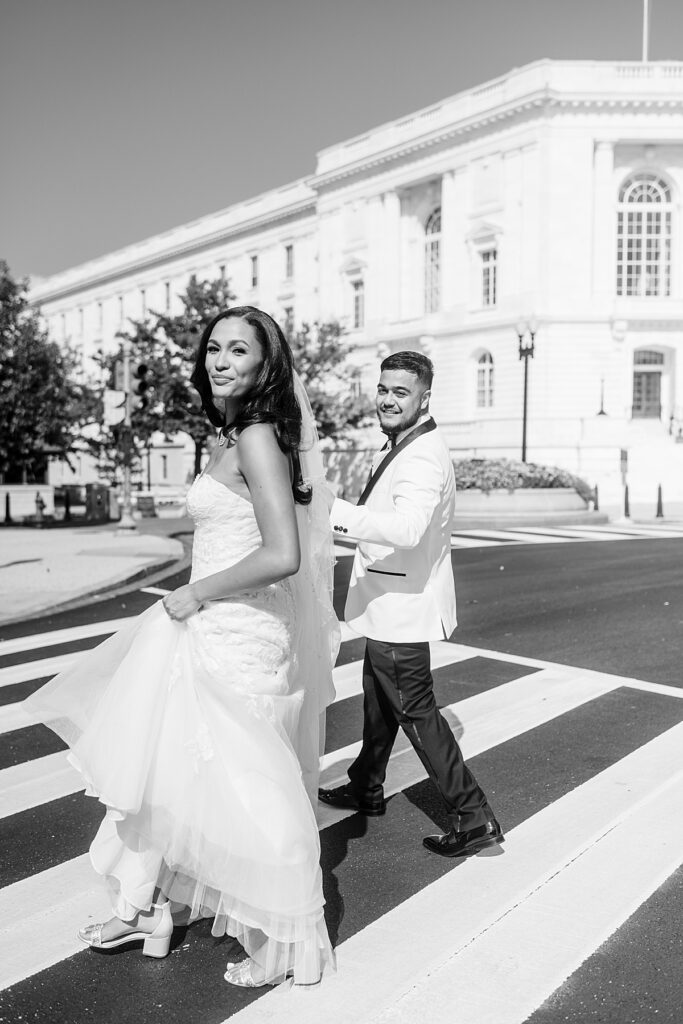 Bride and groom cross Constitution Avenue in DC on their way to wedding at Dock 5.