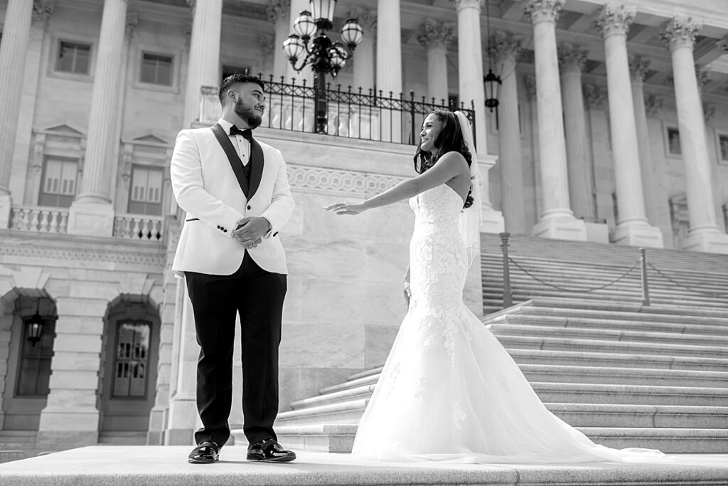 Bride sows her dress to groom at the Capitol, a unique wedding venue in DC for wedding photos.
