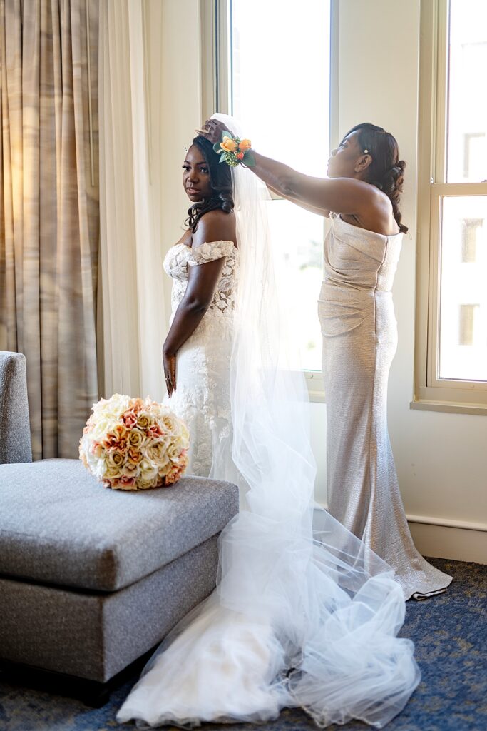 Mother helps her daughter put on her veil | Westin Georgetown Hotel
