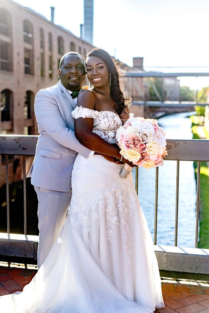 Wedding couple portrait on bride over Georgetown canal | Pinstripes DC