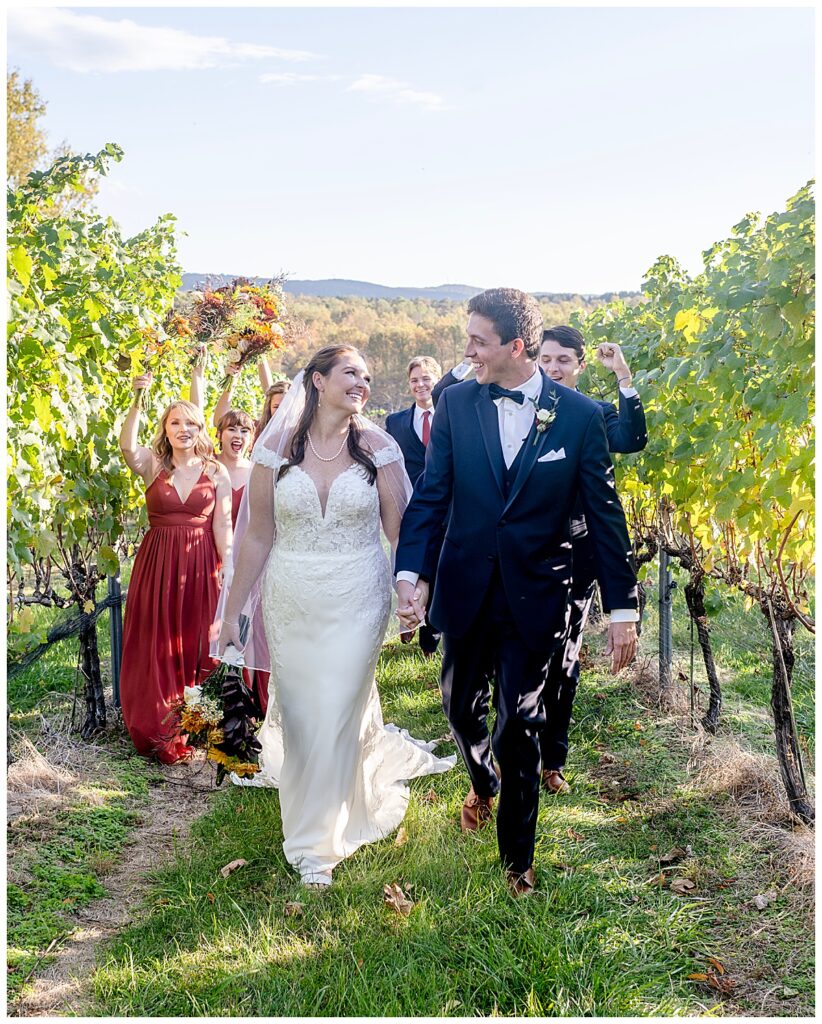 Wedding party stroll through vineyards at Cana Vineyards & Winery