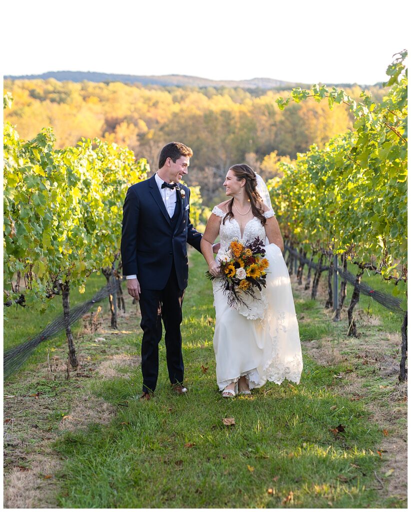 Bride and groom walk through vineyards at Cana Vineyards, wedding venues near DC