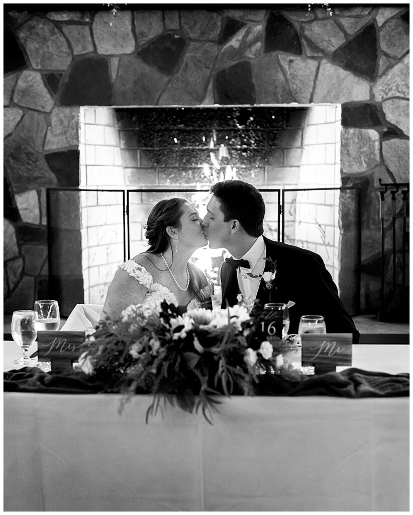 Wedding couple at sweetheart table at Cana Vineyards