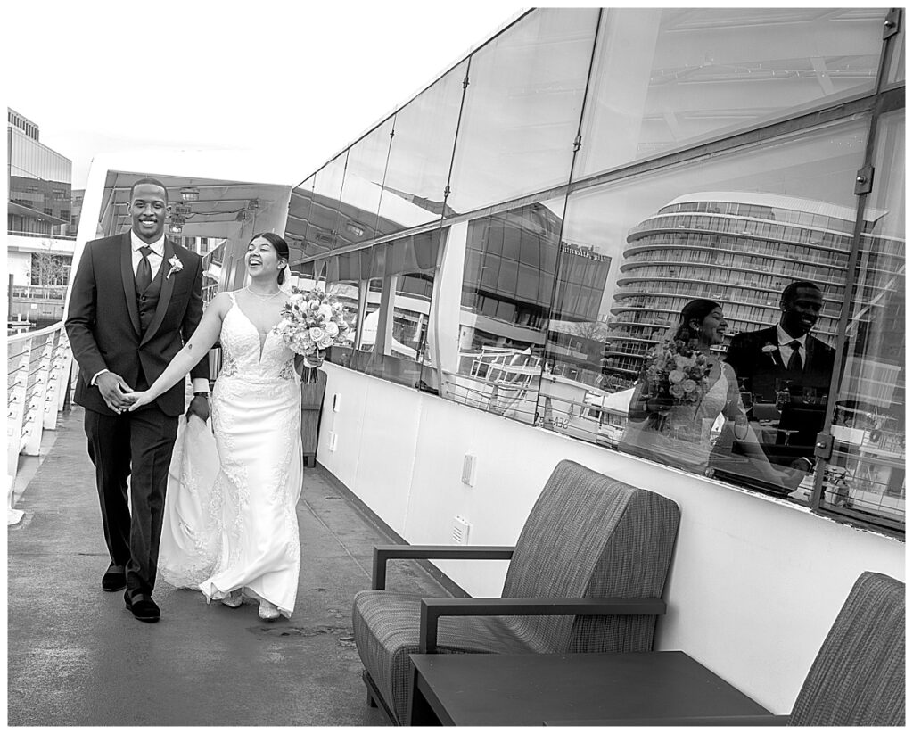 Bride and groom stroll on board the city cruise in DC after their ceremony aboard the boat.
