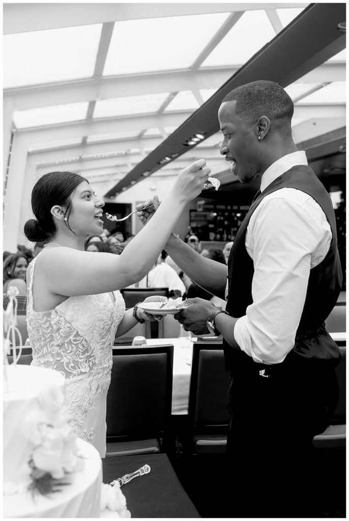 Bride and groom cut their care |Photograher Washington DC wedding aboard the City Cruise Odyssey