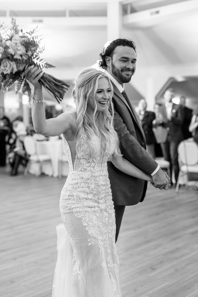 Bride and groom make their grand exit into the Bay Room at Kurtz Beach for their reception