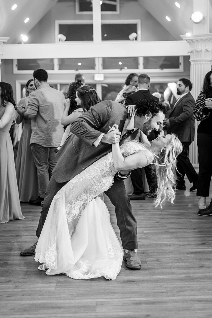 Groom dips his bride at wedding reception