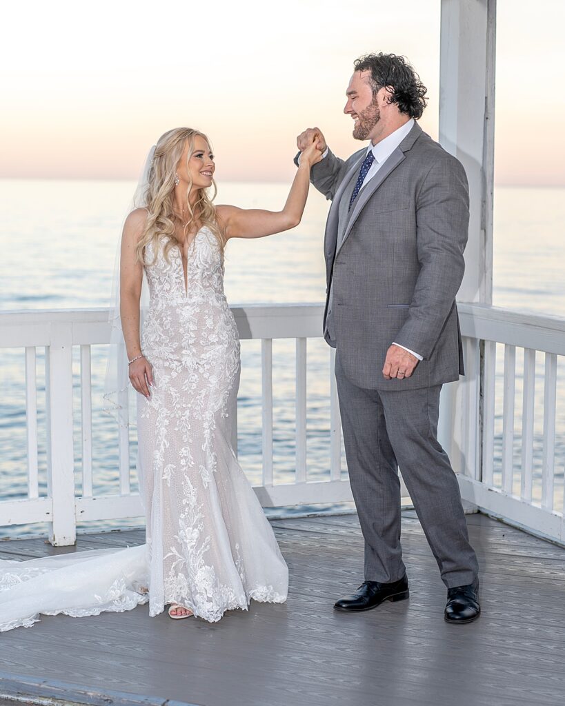 Bride and groom practice their dance at sunset overlooking the Chesapeake Bay at their wedding at Kurtz Beach in Maryland