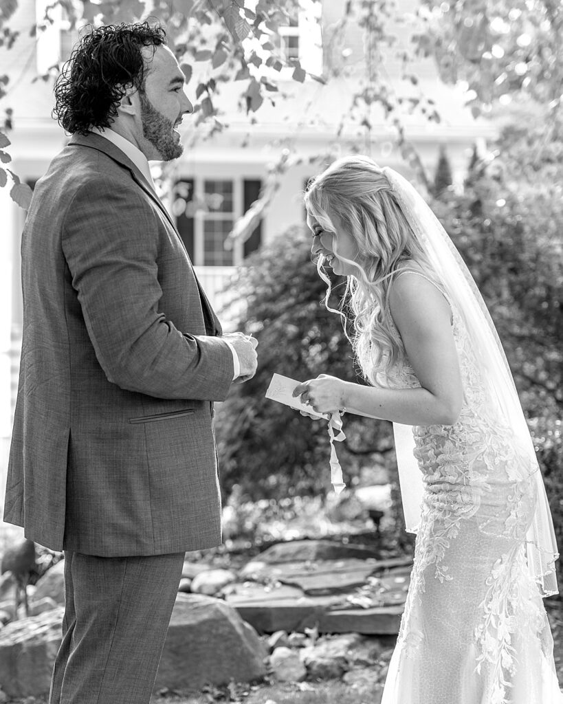 Bride laughs as she reads private vows out loud to her groom before their ceremony, captured by Maryland wedding photographer Nadine Nasby Photography