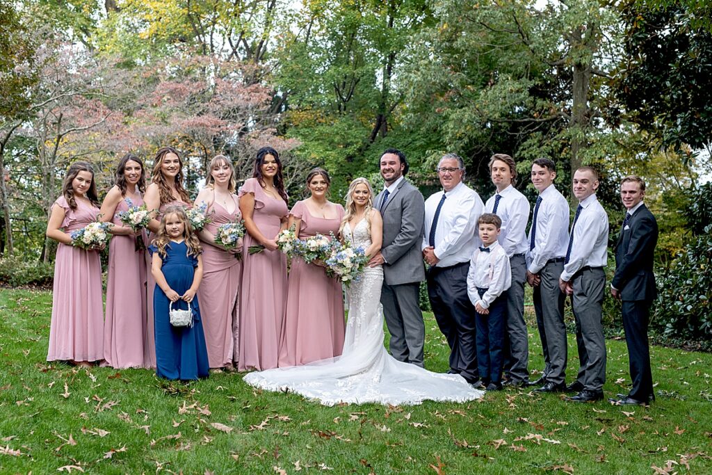 Bridal party formal portrait in the cottage gardens at Kurtz Beach