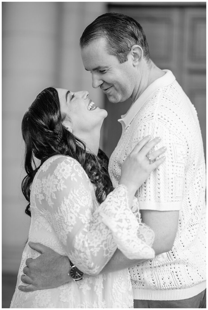 Bride to be looks up at her fiance and laughs captured by their Washington DC engagement photographer.