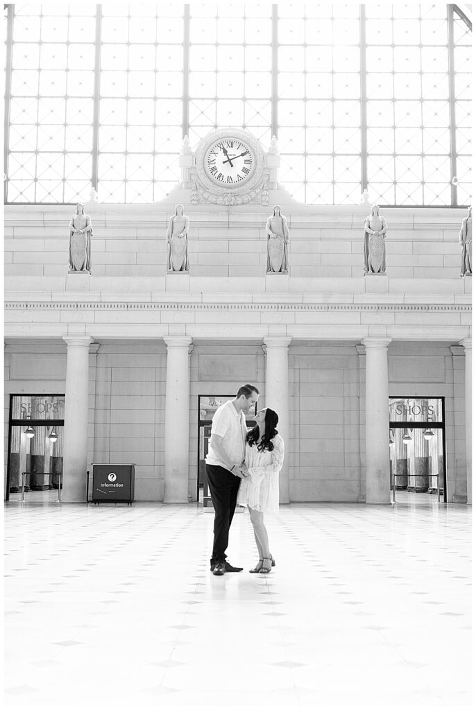 Engaged couple stand Inside Union Station