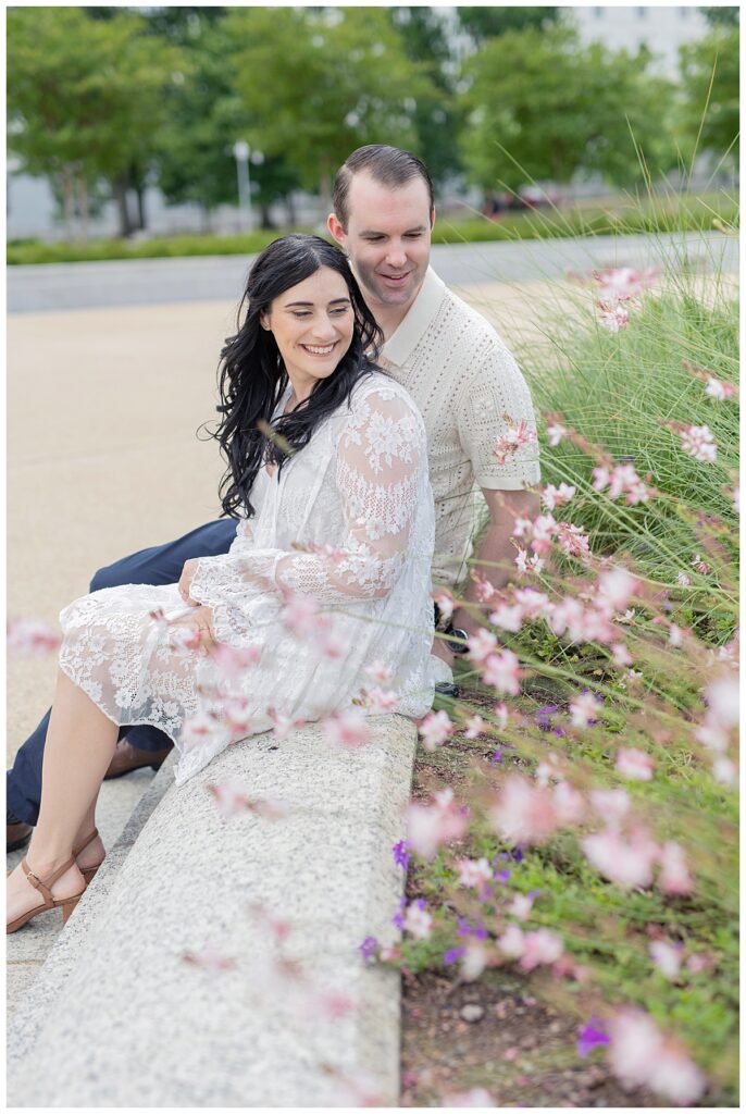 Engaged couple admire the blooming flowers in the park across Union Station DC