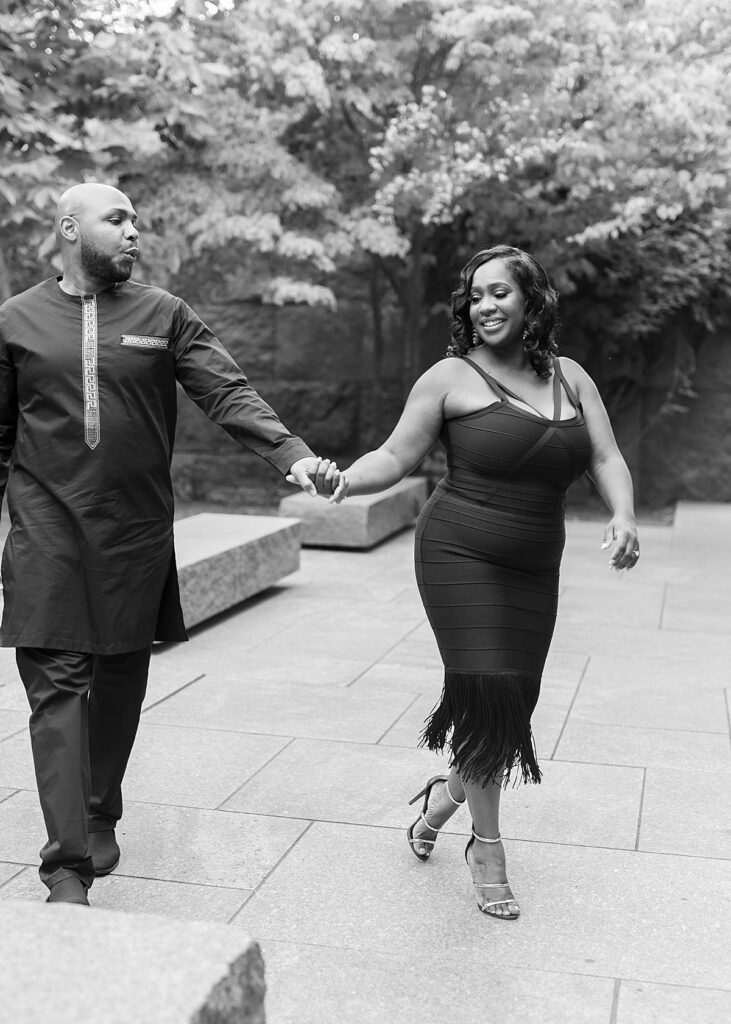 Professional photographer in Washington DC works with getting engaged couple to walk through the FDR Memorial