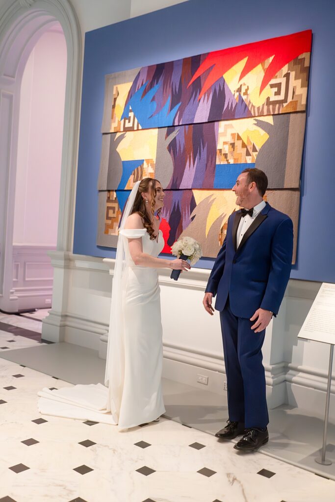 A couple get their first look at one another  with fine art behind them - wedding photography at The Renwick in DC