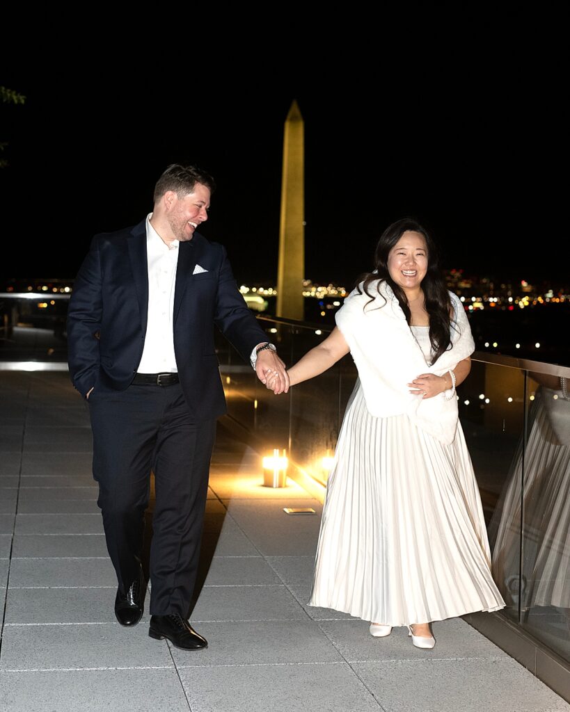 DC photographer photo of bride & groom with monument in background on roof of Old Ebbitt Grill