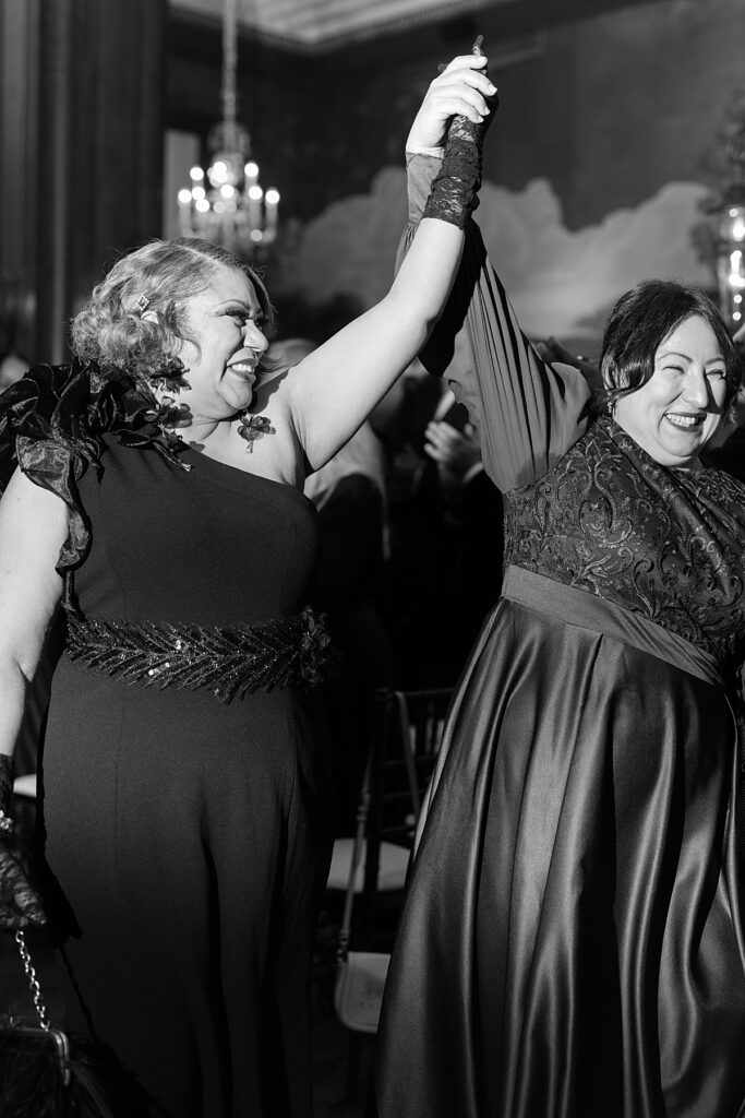 Documentary style wedding photographer DC captures spontaneous joy from mothers of the bride and groom after the ceremony.