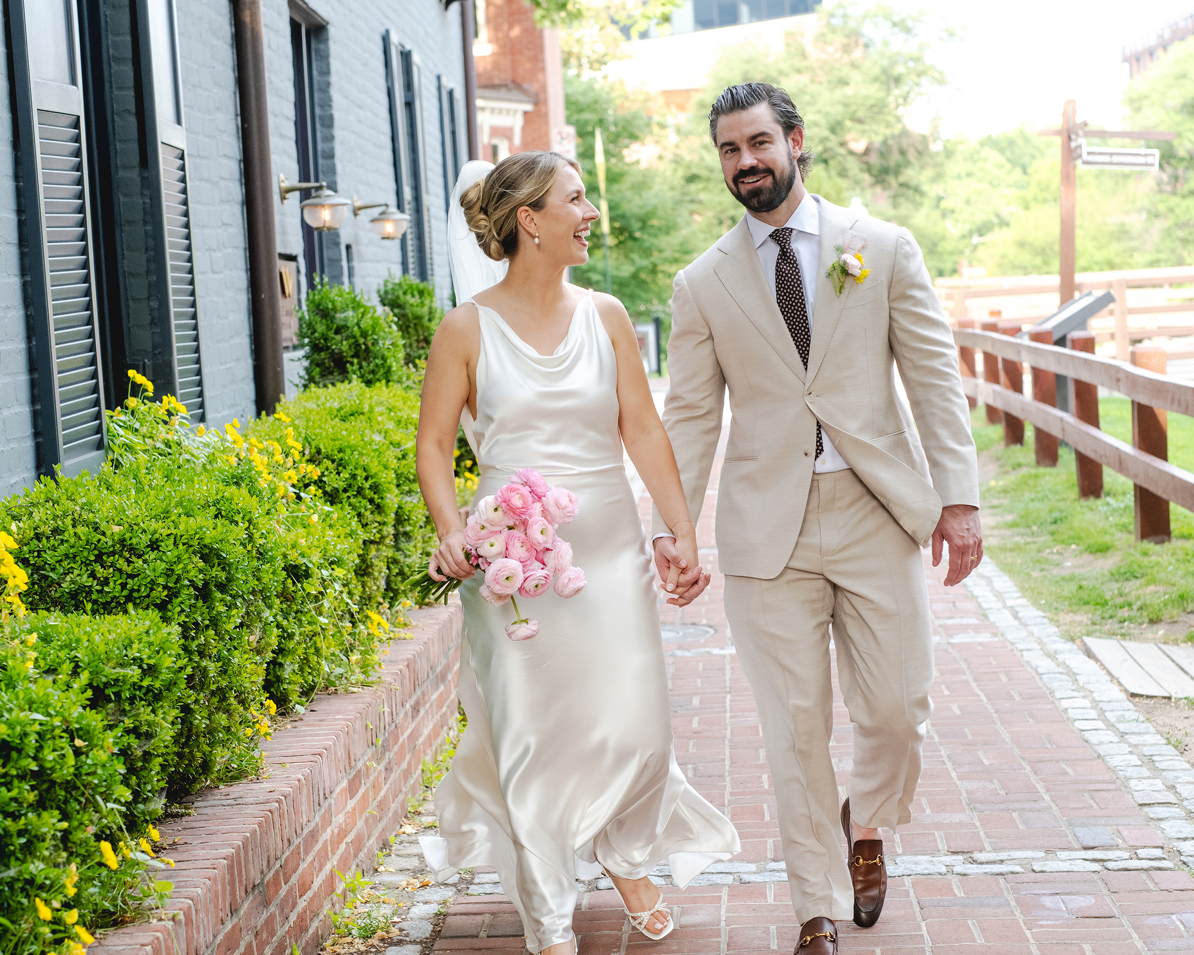 Bride and groom walk down Canal Street in Georgetown on their wedding day.